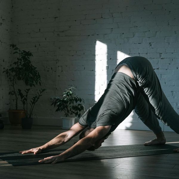 A man stretching in a calm, focused environment, symbolizing well-being.